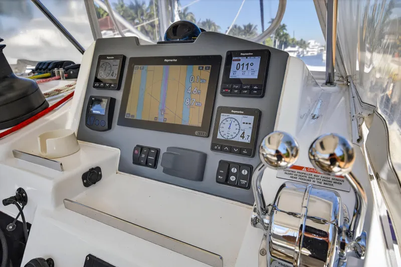  Yacht Photos Pics Control panel of a 2021 Leopard 50 yacht with navigation instruments and throttle levers.