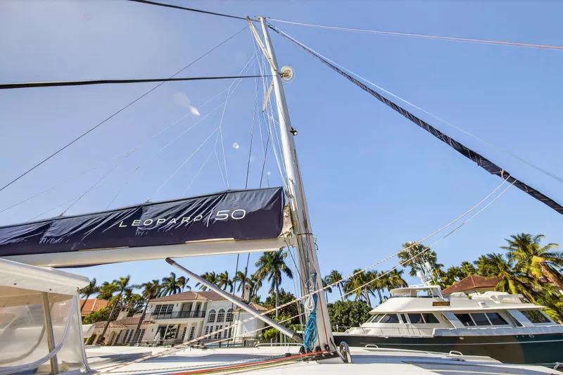  Yacht Photos Pics Sailboat Leopard 50, 2021 model, docked near palm trees and luxury homes.