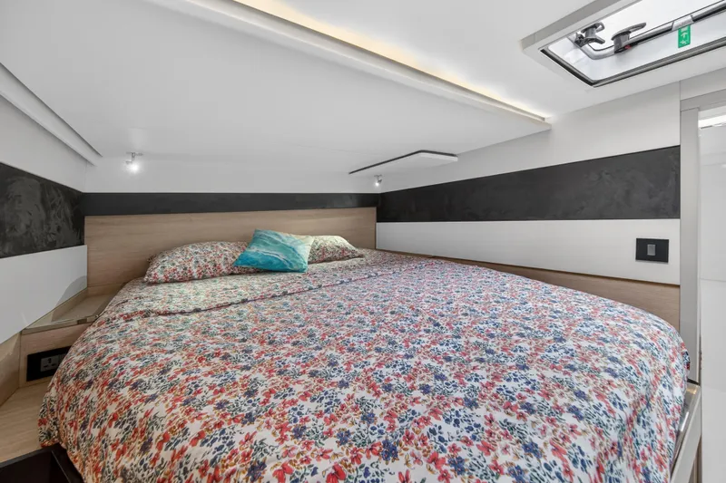  Yacht Photos Pics Cozy bedroom in 2021 Leopard 50 yacht with floral bedding and modern design.