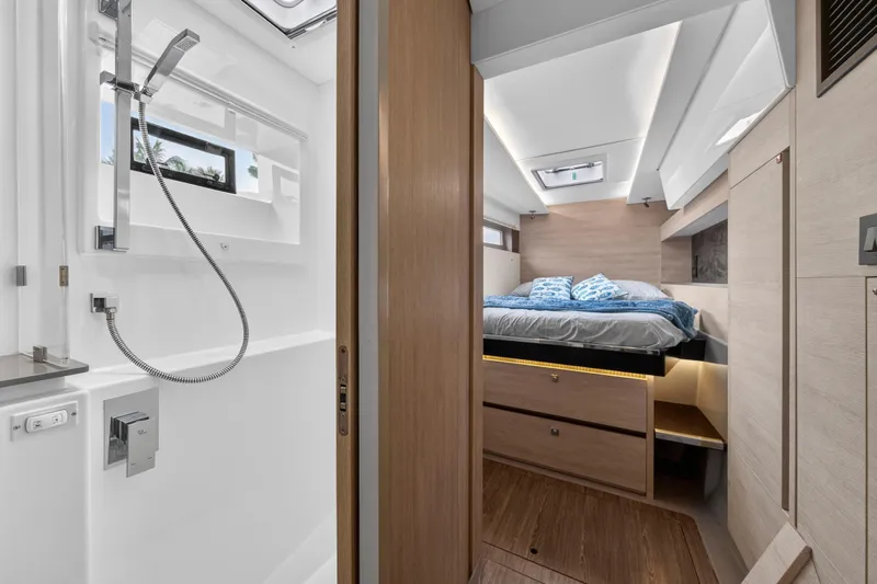  Yacht Photos Pics Modern Leopard 50 yacht interior with bedroom and bathroom, featuring sleek design and wood finishes.