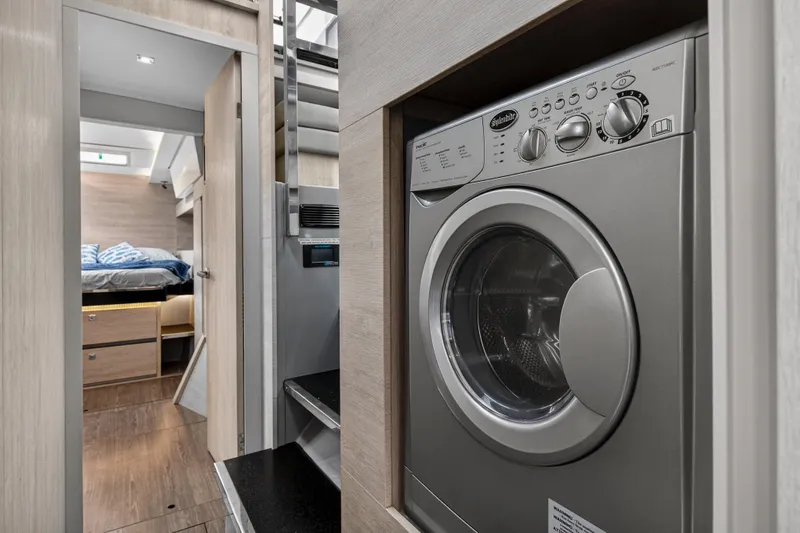  Yacht Photos Pics Laundry area in a 2021 Leopard 50 yacht, featuring a modern washing machine.