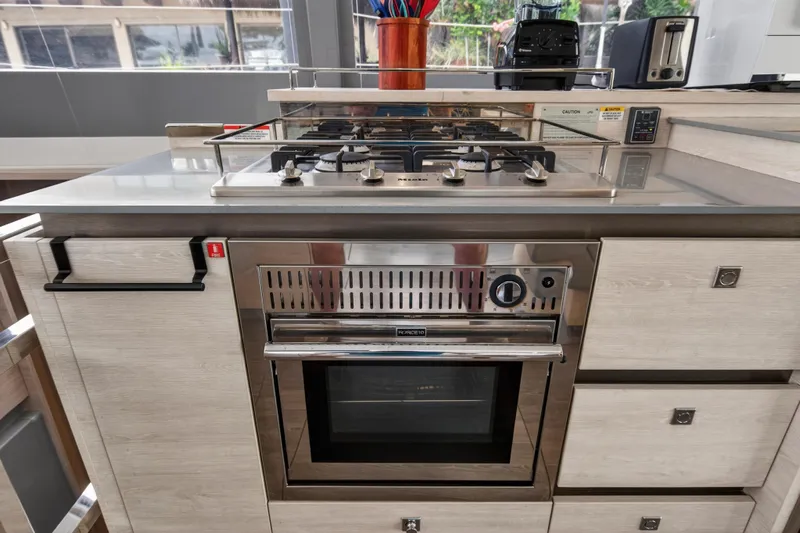  Yacht Photos Pics Modern kitchen with stainless steel oven and stovetop on Leopard 50 yacht, 2021 model.