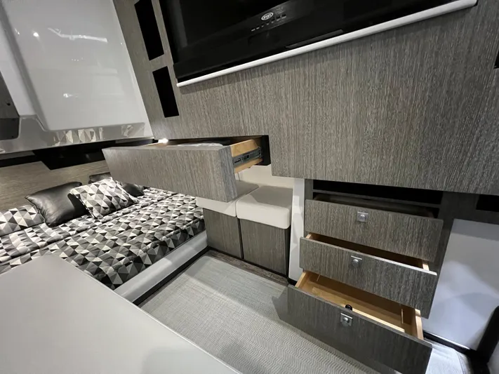 Livin Life Yacht Photos Pics 2023 Monterey 378SS Super Sport interior with modern cabinetry and geometric-patterned bedding.