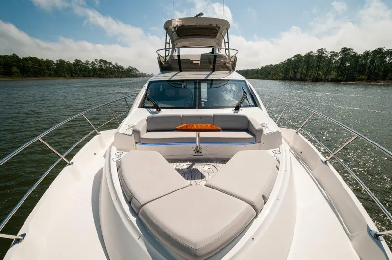 Lady Gail Yacht Photos Pics 2018 Sea Ray L550 Flybridge yacht on a serene river with lush greenery.