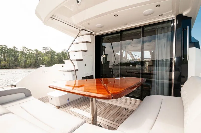 Lady Gail Yacht Photos Pics 2018 Sea Ray L550 Flybridge yacht with elegant outdoor seating and polished wooden table.