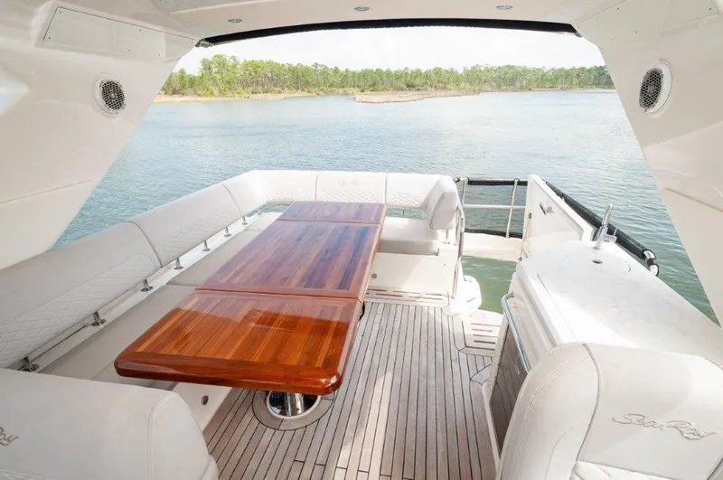 Lady Gail Yacht Photos Pics Luxurious 2018 Sea Ray L550 Flybridge yacht with spacious outdoor seating and elegant wooden table.