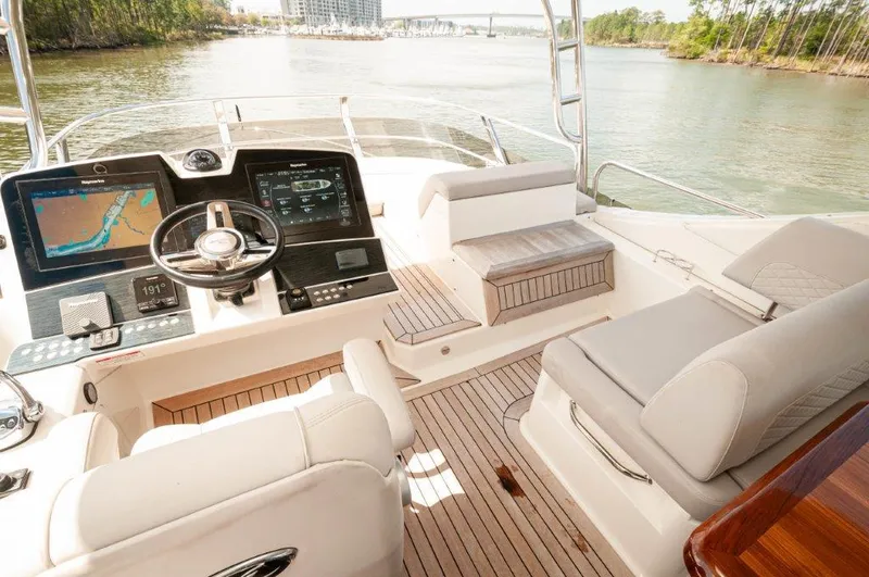 Lady Gail Yacht Photos Pics 2018 Sea Ray L550 Flybridge with modern helm, luxurious seating, and scenic waterway view.