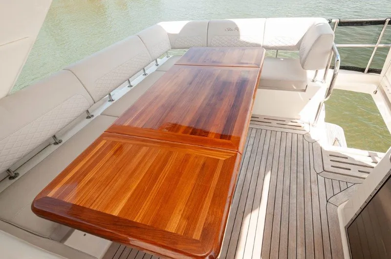 Lady Gail Yacht Photos Pics Luxurious 2018 Sea Ray L550 Flybridge with elegant wooden dining table and cushioned seating.