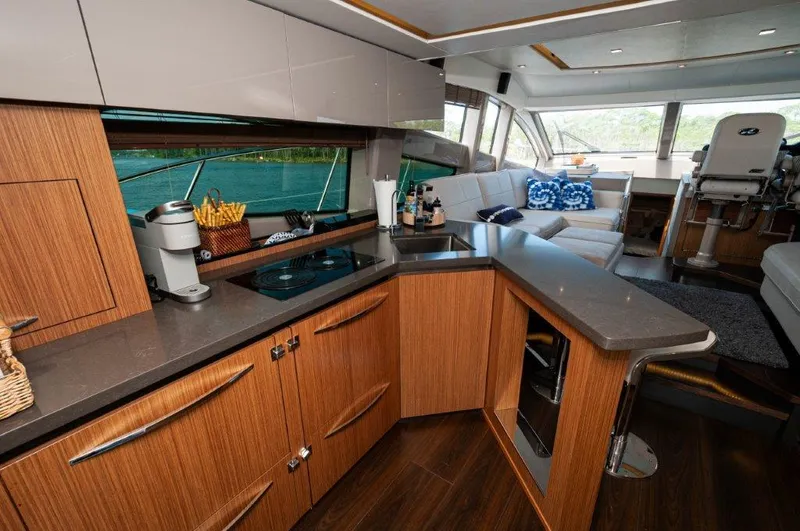 Lady Gail Yacht Photos Pics Luxurious interior of 2018 Sea Ray L550 Flybridge yacht with modern kitchen and seating area.