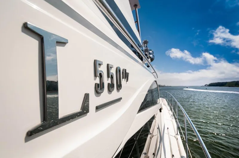 Lady Gail Yacht Photos Pics 2018 Sea Ray L550 Flybridge yacht cruising on open water under a clear blue sky.