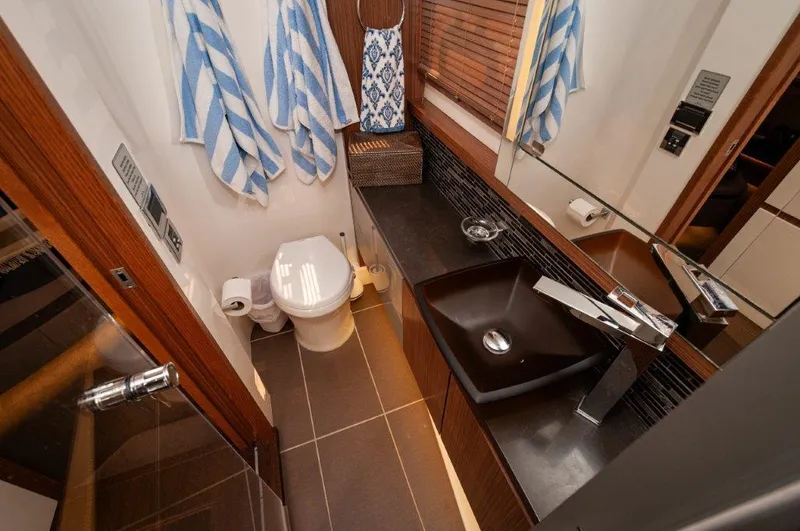 Lady Gail Yacht Photos Pics Luxurious bathroom in 2018 Sea Ray L550 Flybridge yacht with modern fixtures and elegant design.