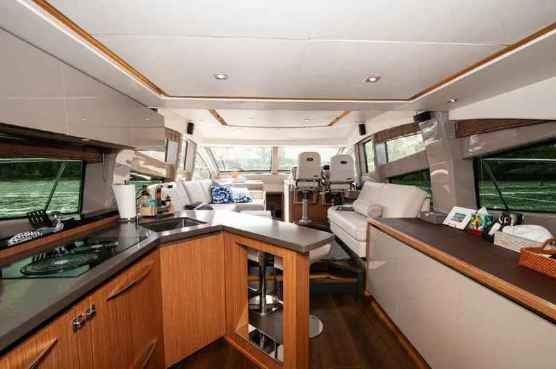 Lady Gail Yacht Photos Pics Luxurious interior of 2018 Sea Ray L550 Flybridge yacht with modern kitchen and seating area.