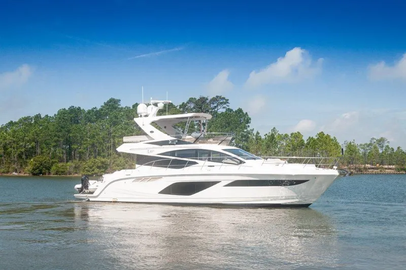 Lady Gail Yacht Photos Pics 2018 Sea Ray L550 Flybridge yacht cruising on a serene lake with forested background.