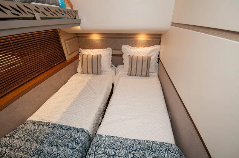 Lady Gail Yacht Photos Pics Twin beds in 2018 Sea Ray L550 Flybridge cabin with elegant bedding and ambient lighting.