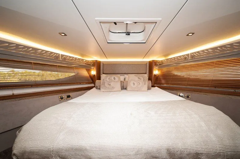 Lady Gail Yacht Photos Pics Luxurious bedroom interior of 2018 Sea Ray L550 Flybridge yacht with elegant lighting.