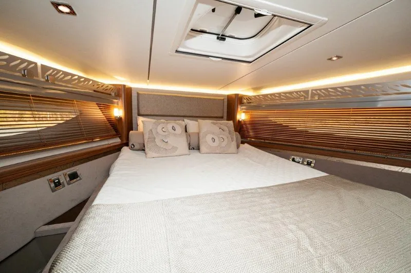 Lady Gail Yacht Photos Pics Luxurious bedroom interior of 2018 Sea Ray L550 Flybridge yacht with elegant bedding and lighting.