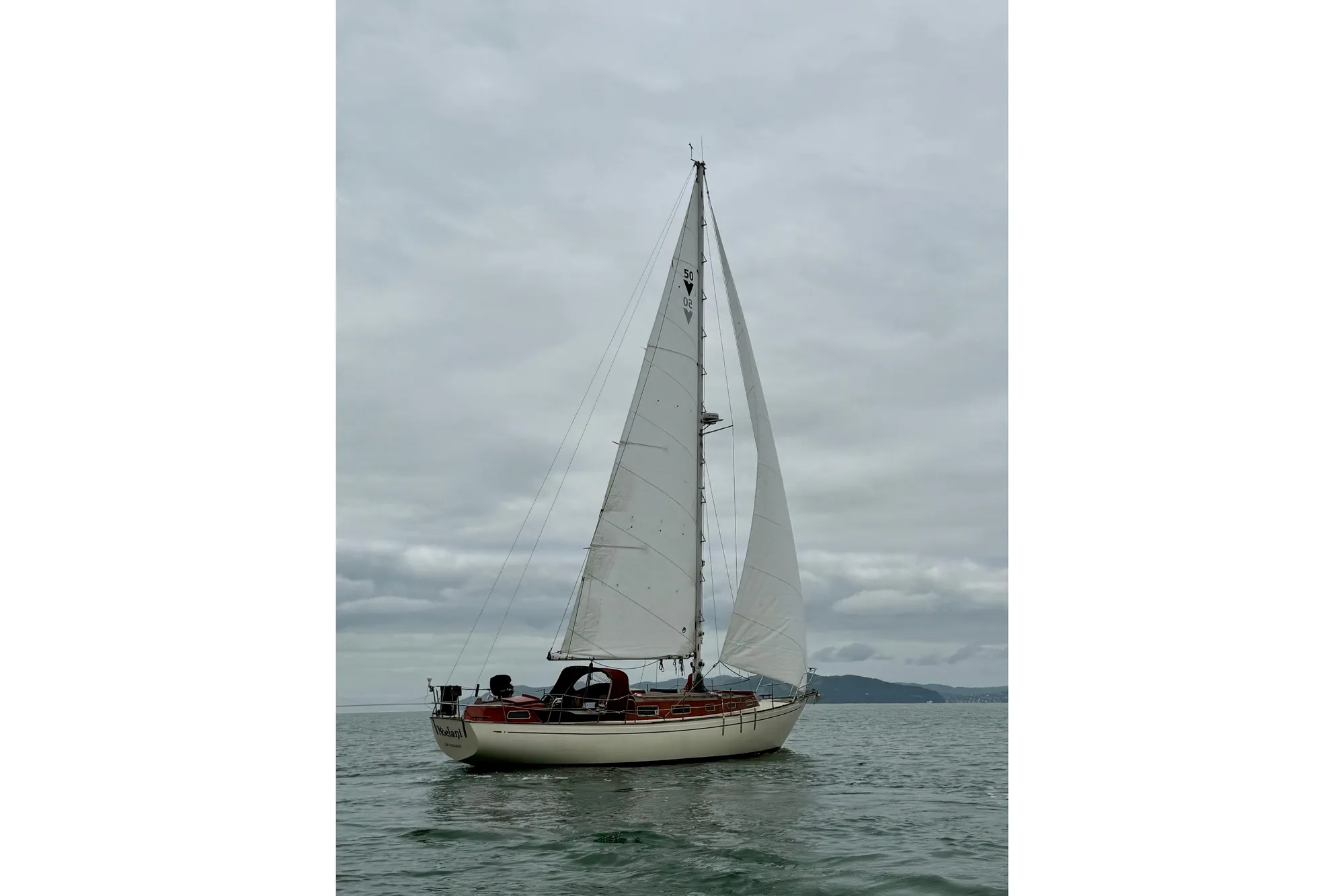 1978 Vindo 50 sailboat on calm waters under cloudy skies.