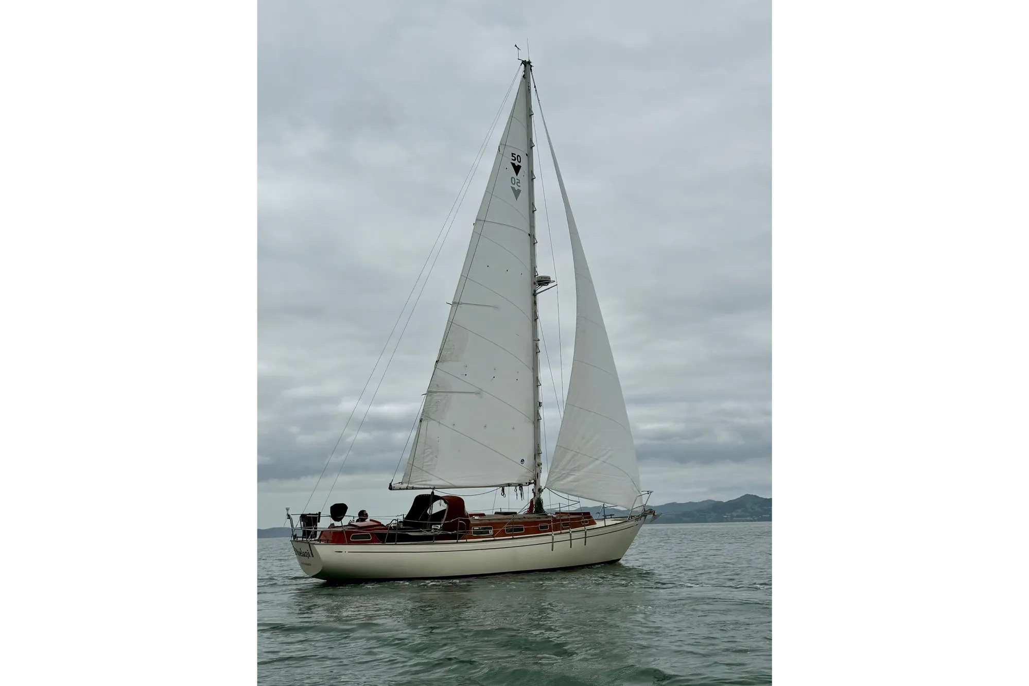 1978 Vindo 50 sailboat on calm waters under cloudy skies.