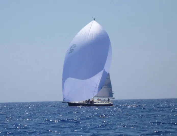 Condor Yacht Photos Pics Sailing yacht J/160 from 1996 with a large white spinnaker on open sea.