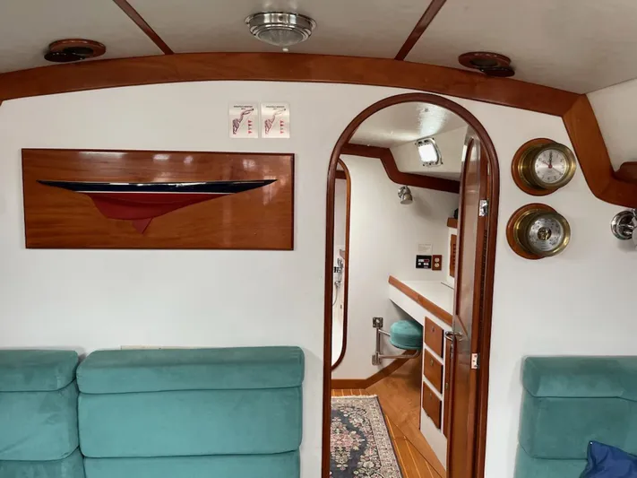 Condor Yacht Photos Pics Interior of 1996 J Boats J/160 yacht with teal seating and wooden accents.