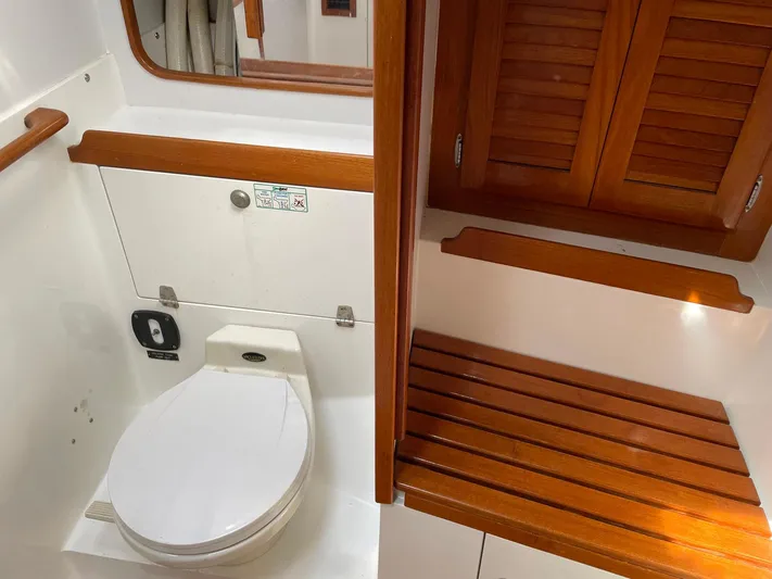 Condor Yacht Photos Pics Interior of 1996 J Boats J/160 yacht bathroom with wooden accents and toilet.