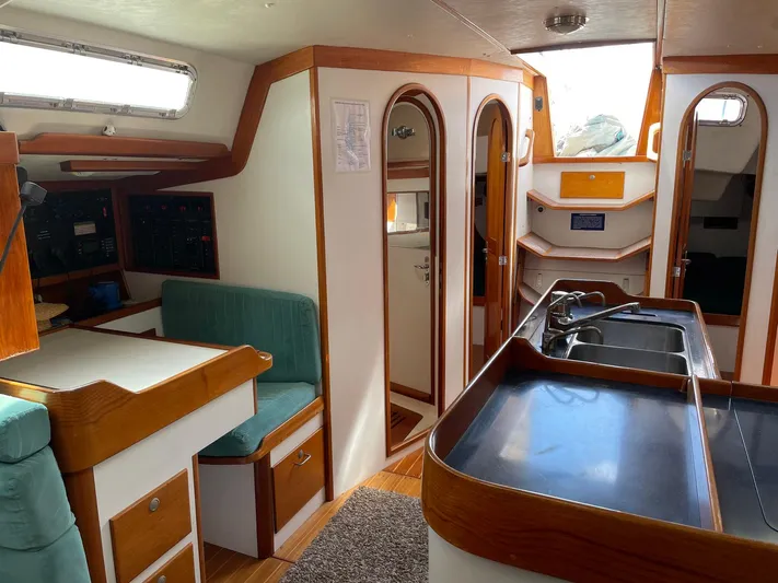 Condor Yacht Photos Pics Interior of 1996 J Boats J/160 sailboat with wood accents and modern amenities.