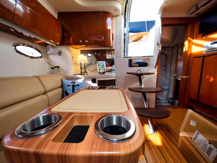 Syrenka Yacht Photos Pics Interior of 2008 Regal Commodore 4060 yacht with wooden table and modern amenities.