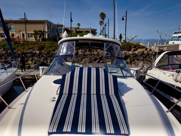 Syrenka Yacht Photos Pics 2008 Regal Commodore 4060 yacht docked at marina with striped sunbed.
