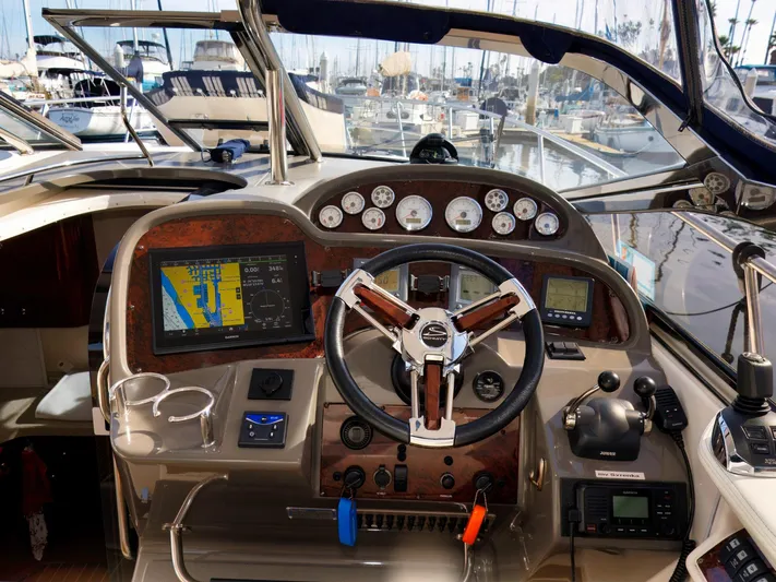 Syrenka Yacht Photos Pics Cockpit of 2008 Regal Commodore 4060 yacht with navigation instruments and steering wheel.