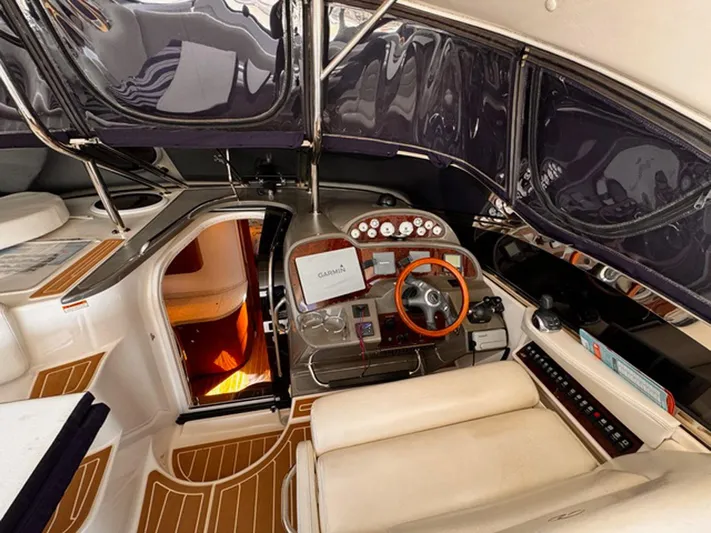 Syrenka Yacht Photos Pics 2008 Regal Commodore 4060 yacht interior with helm, wooden accents, and modern navigation equipment.