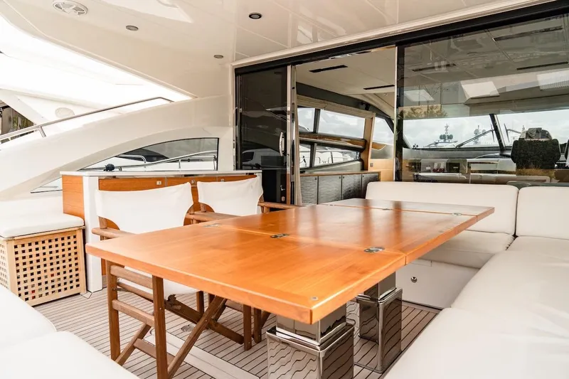  Yacht Photos Pics Luxurious 2012 Princess V72 yacht interior with elegant wooden dining table and white seating.