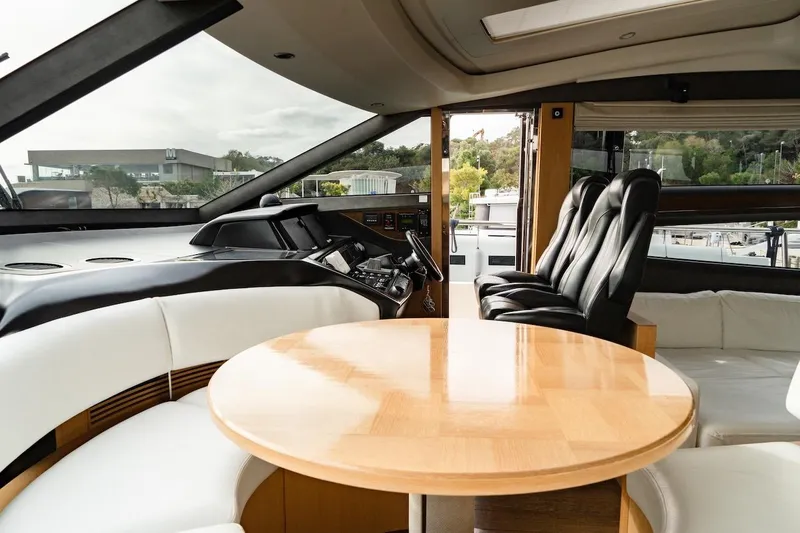  Yacht Photos Pics Luxurious interior of 2012 Princess V72 yacht with elegant seating and wooden table.