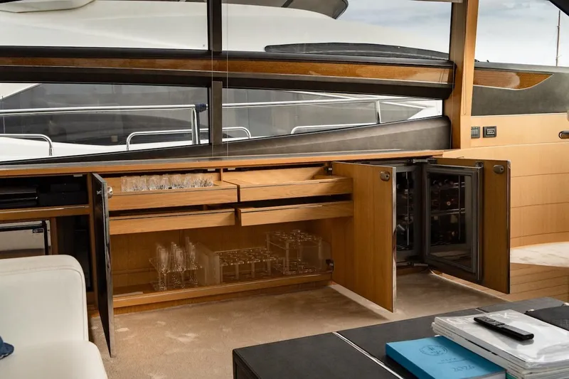  Yacht Photos Pics Luxurious interior of 2012 Princess V72 yacht with open cabinets and glassware.