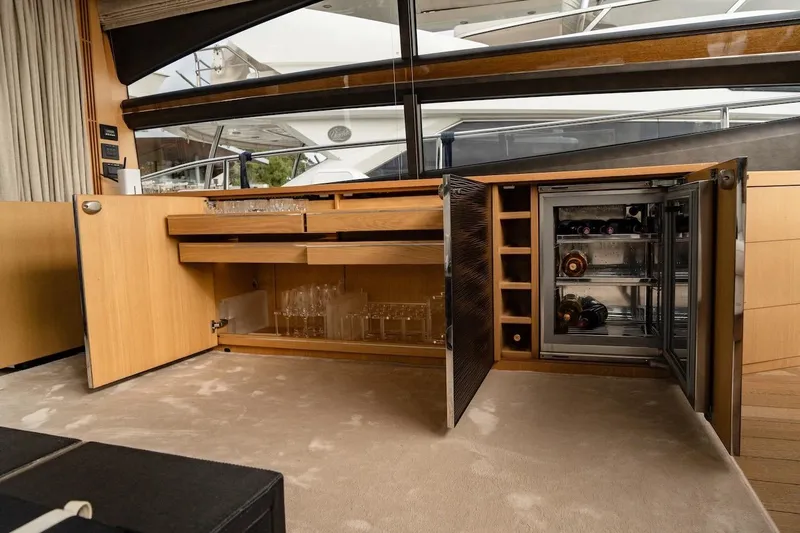  Yacht Photos Pics Luxurious interior of 2012 Princess V72 yacht with open bar cabinet and wine fridge.