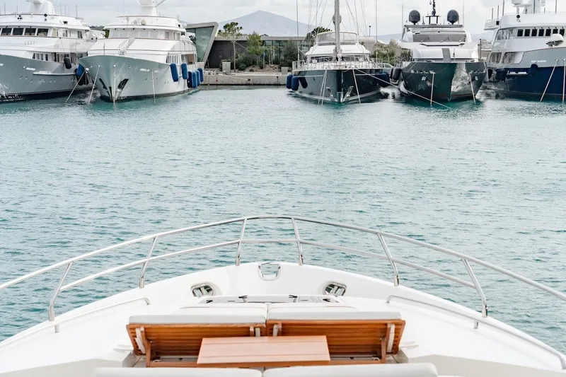  Yacht Photos Pics Bow view of 2012 Princess V72 yacht in marina with luxury boats.