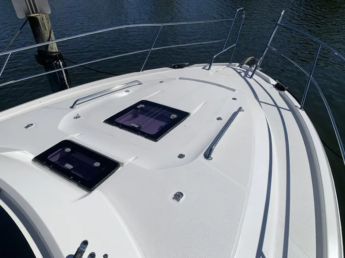  Yacht Photos Pics 2015 Bavaria S36 Coupe boat deck with hatches, docked on calm water.