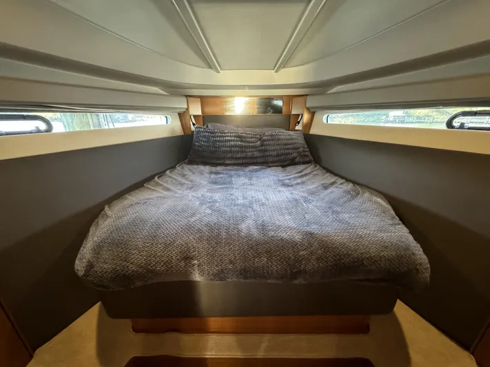  Yacht Photos Pics Interior cabin of 2015 Bavaria S36 Coupe with cozy bed and side windows.