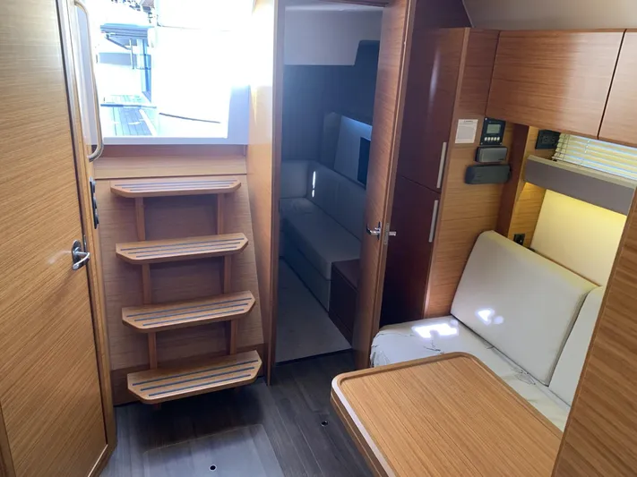  Yacht Photos Pics Interior of 2015 Bavaria S36 Coupe yacht with wooden finish and cozy seating area.