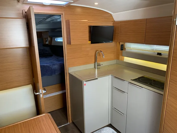  Yacht Photos Pics Interior of 2015 Bavaria S36 Coupe yacht with modern kitchen and cozy cabin.