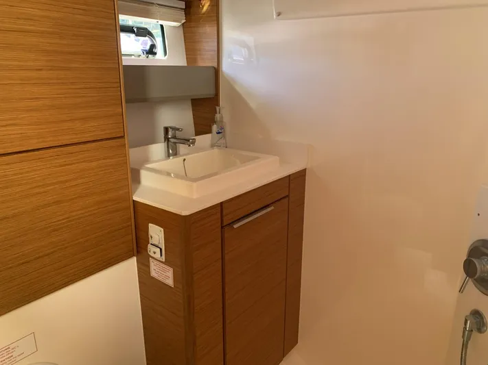  Yacht Photos Pics Bathroom interior of 2015 Bavaria S36 Coupe with wooden cabinetry and modern sink.