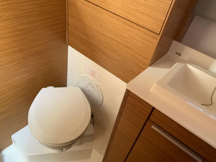  Yacht Photos Pics Bathroom interior of 2015 Bavaria S36 Coupe with wooden cabinetry and modern fixtures.