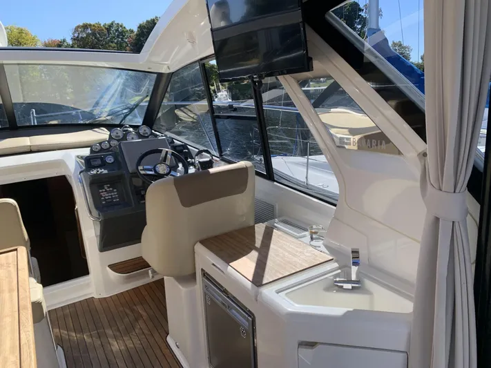  Yacht Photos Pics Interior of 2015 Bavaria S36 Coupe boat with steering wheel and modern amenities.