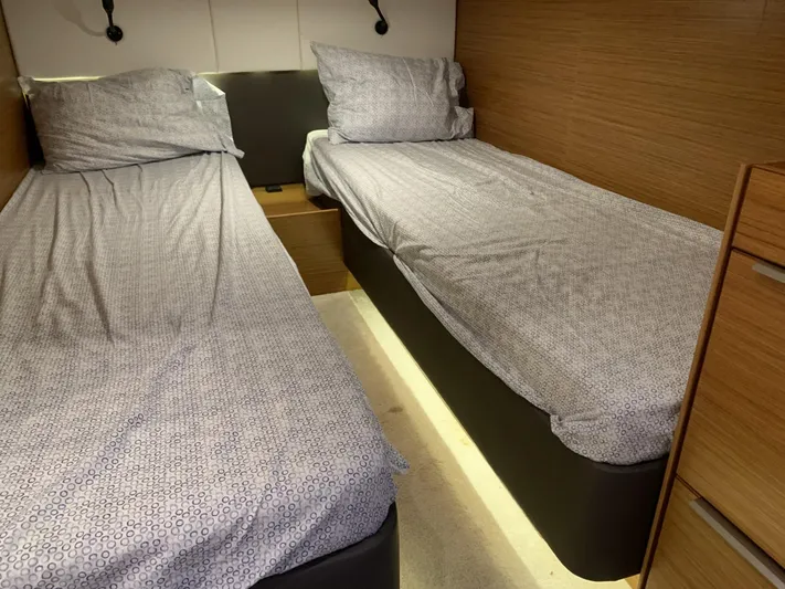  Yacht Photos Pics Twin beds in a 2015 Bavaria S36 Coupe cabin with modern wood paneling.