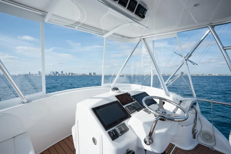 Reelin N Dealin Yacht Photos Pics 2018 Viking 37 Billfish helm with ocean view and city skyline in the background.