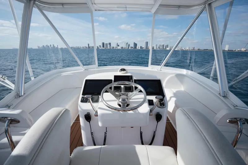 Reelin N Dealin Yacht Photos Pics Helm of 2018 Viking 37 Billfish yacht with city skyline view.