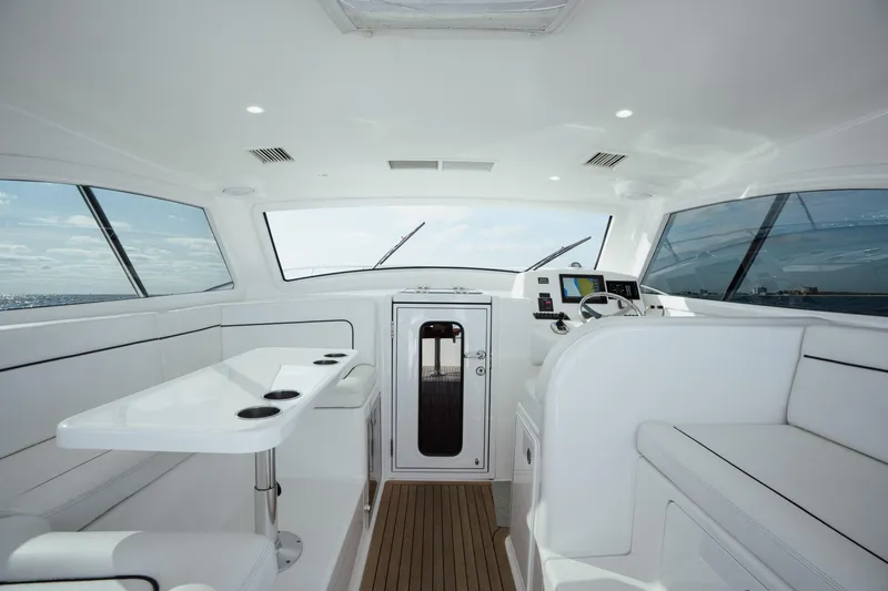 Reelin N Dealin Yacht Photos Pics Interior of 2018 Viking 37 Billfish yacht, featuring sleek white seating and modern controls.