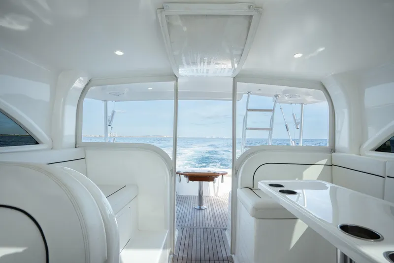 Reelin N Dealin Yacht Photos Pics Interior view of 2018 Viking 37 Billfish yacht, featuring sleek seating and ocean backdrop.