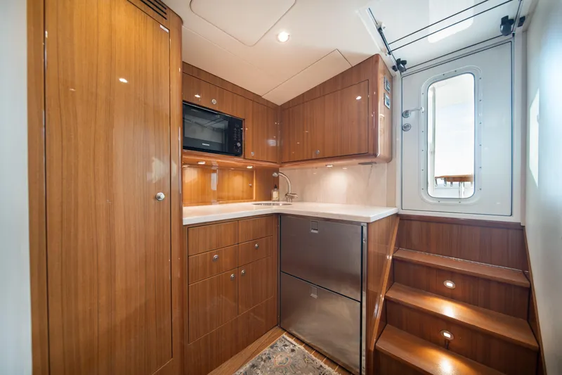 Reelin N Dealin Yacht Photos Pics Luxurious 2018 Viking 37 Billfish yacht interior with modern kitchen and wooden cabinetry.