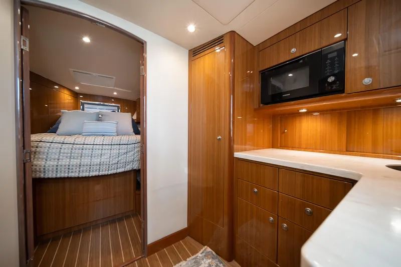 Reelin N Dealin Yacht Photos Pics Luxurious interior of 2018 Viking 37 Billfish yacht with cozy bedroom and modern kitchenette.