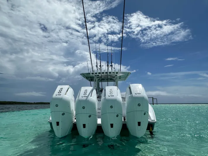  Yacht Photos Pics 2024 Yellowfin 39 boat with four powerful outboard engines on clear turquoise water.